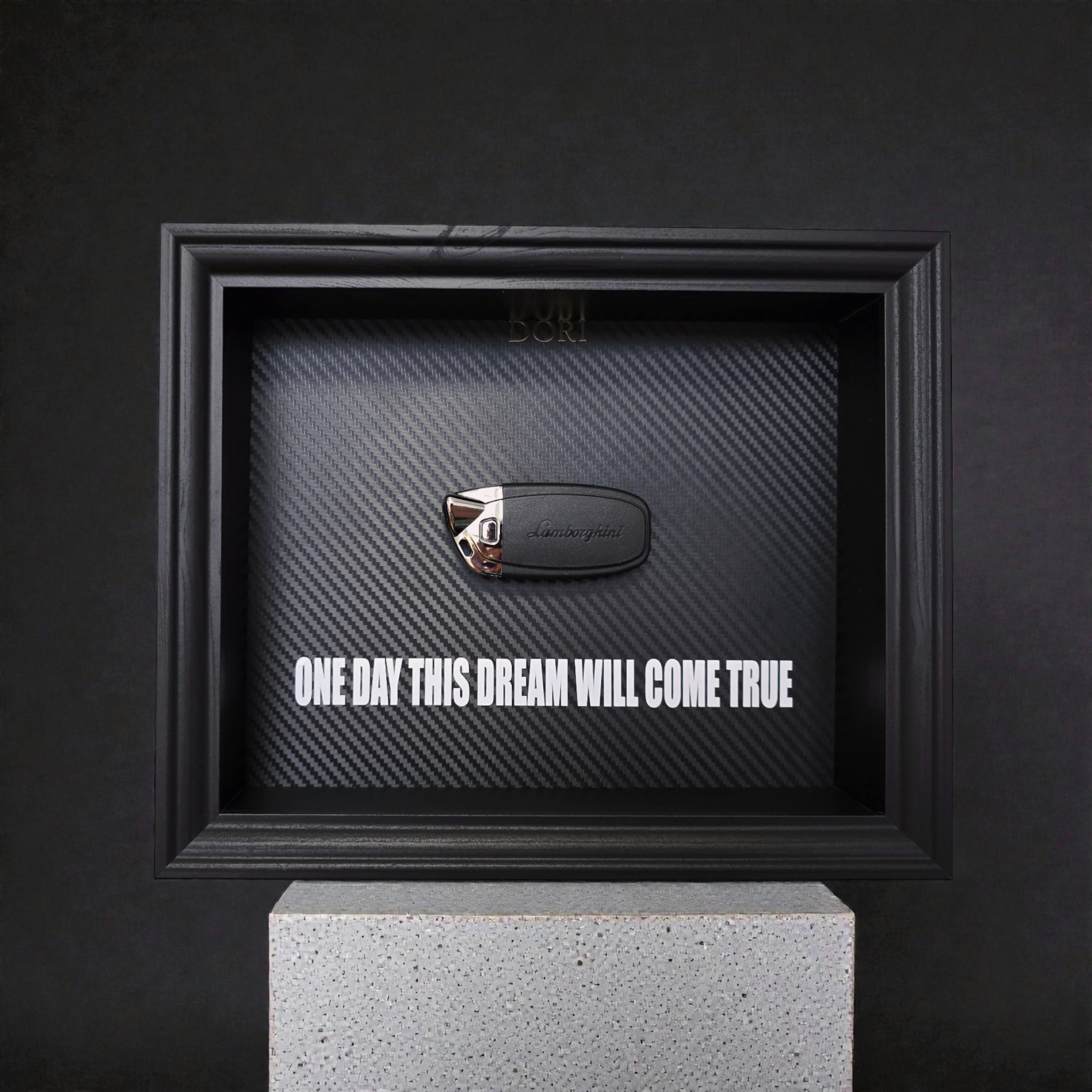 Automobilio raktelio dekoratyvinis paveikslas su anglies pluošto fonu ir užrašu „One Day This Dream Will Come True“