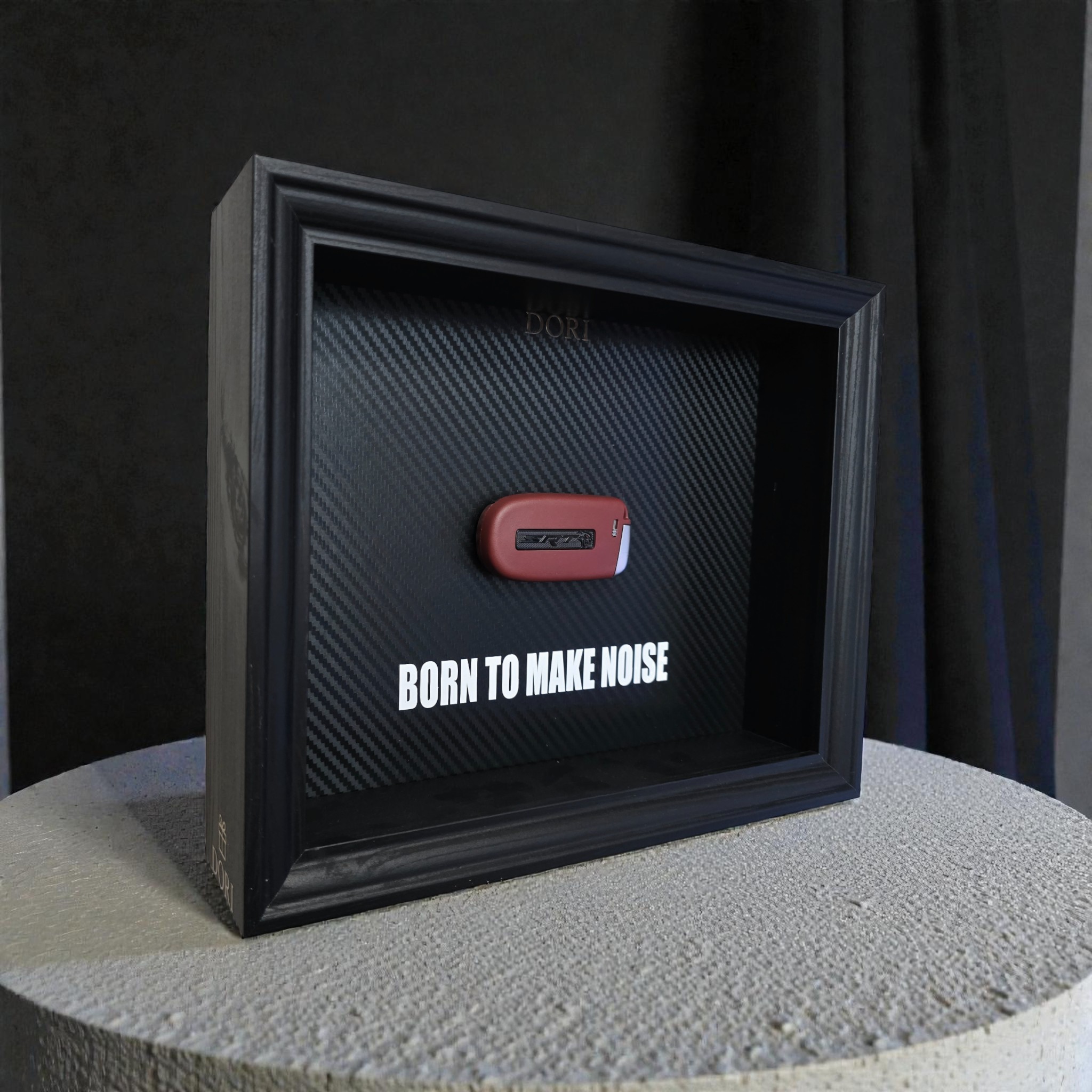 Automobilio raktelio dekoratyvinis paveikslas su anglies pluošto fonu ir užrašu „Born to Make Noise“