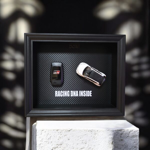 DORI motyvacinis paveikslas su Toyota GR rakteliu ir fraze Racing DNA Inside